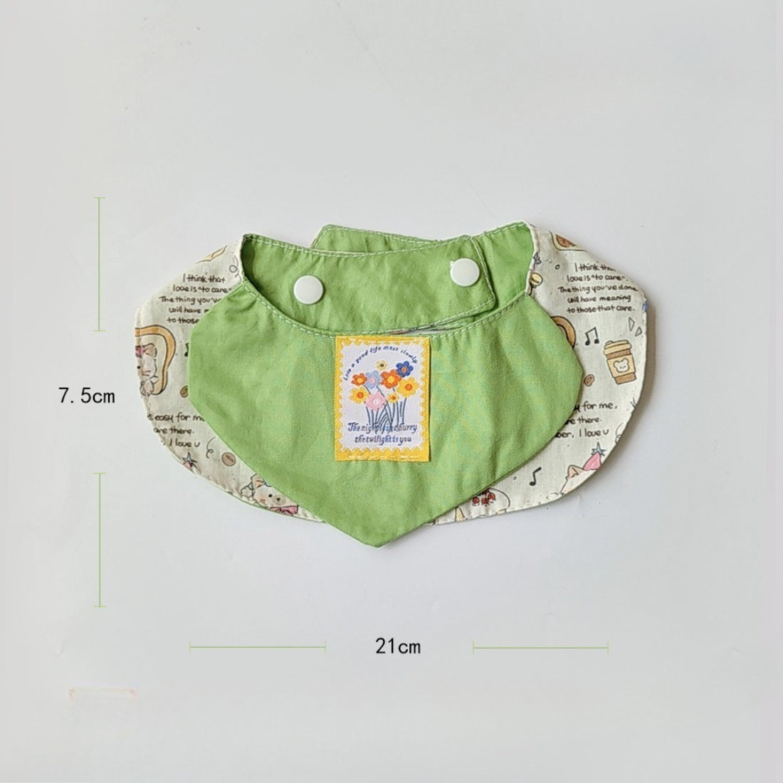Mokka bib laid flat showing full cartoon cat artwork and shape