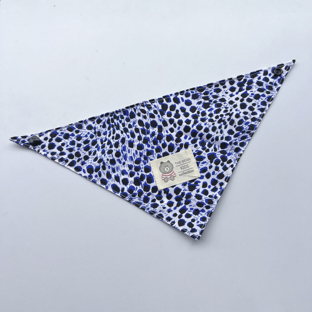Blue leopard-print triangular pet neckwear laid flat with corner snaps and bear label
