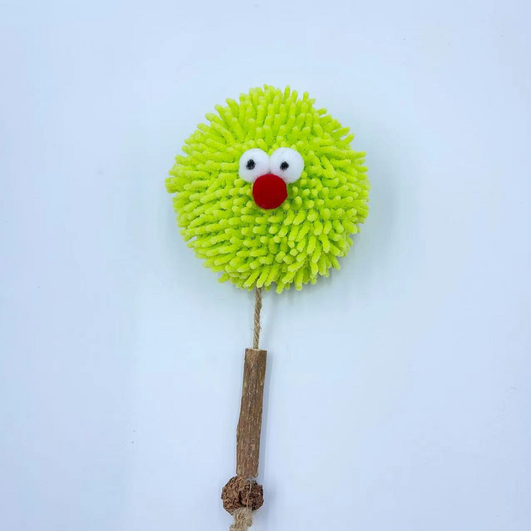 Front view of the green Ball cat toy with its cord and narrow brown section extended below