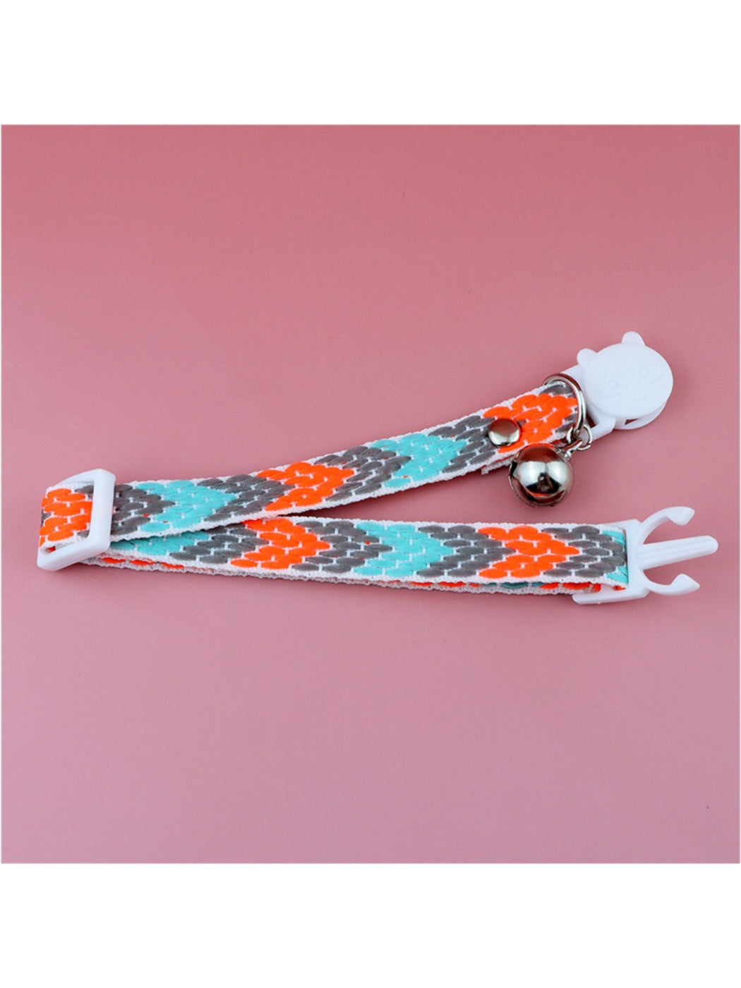 Bright geometric cat collar laid flat displaying full pattern and hardware