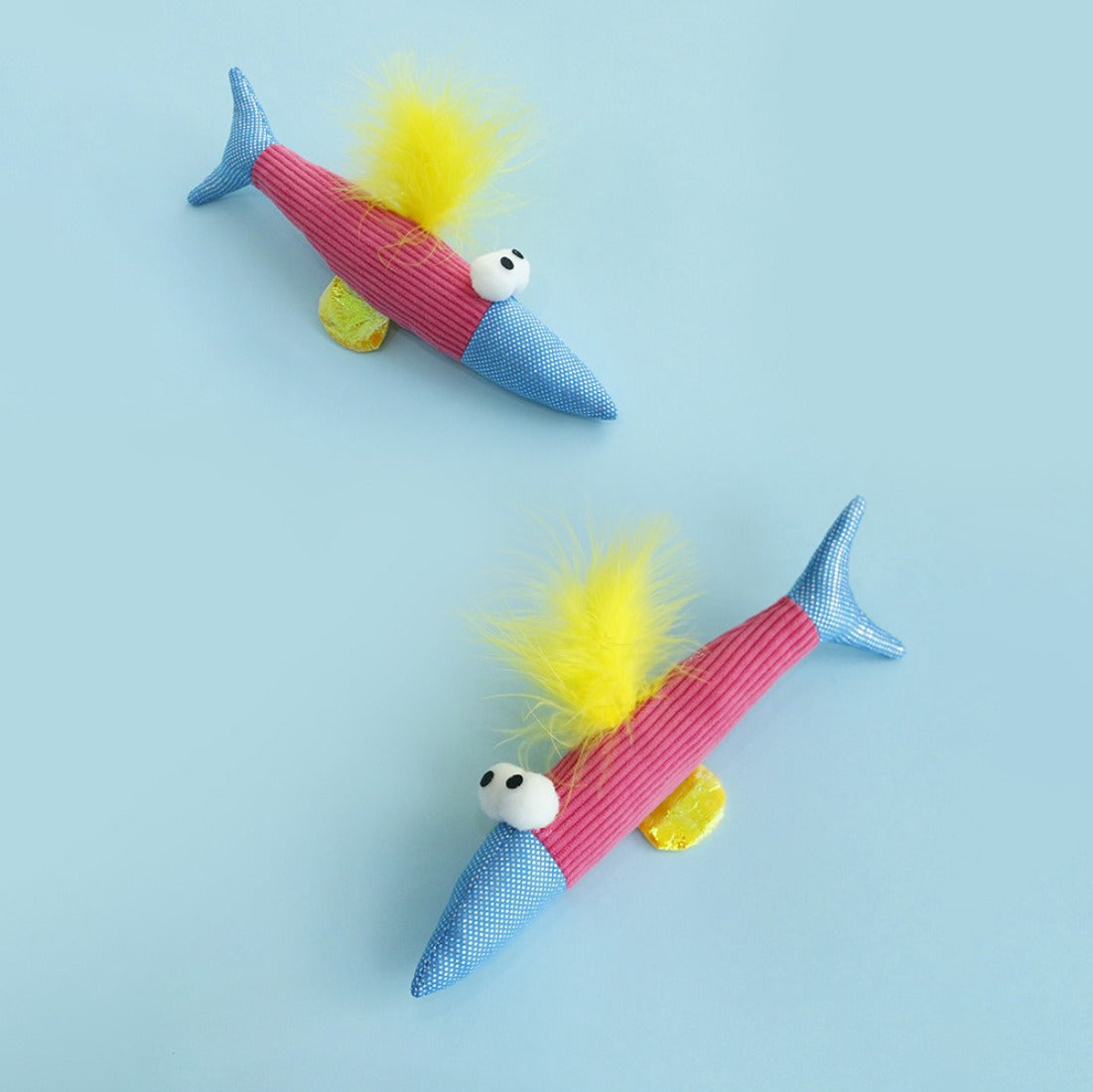 Moo colorful feather fish cat toy shown from an angle highlighting colorful feather pattern