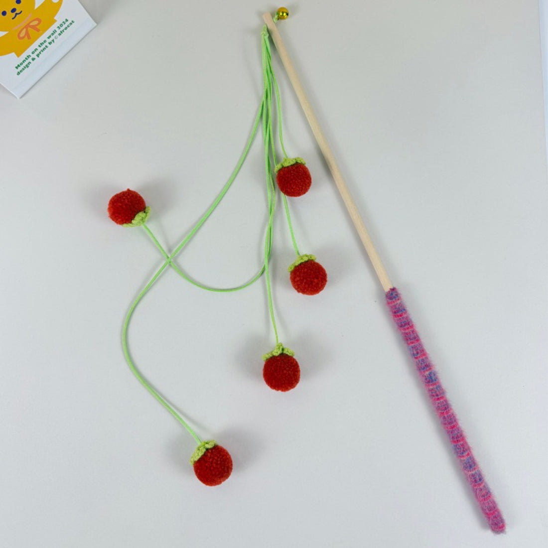Moo Fruit Wand cat toy packaging with orange pom pom teaser visible