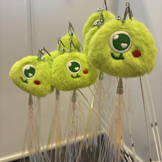 Close-up of Moo interactive cat toy pom figure attached to telescopic wand