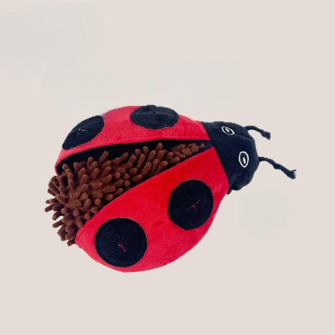 Snuffy plush toy folded to show multiple compartments for hiding dog treats