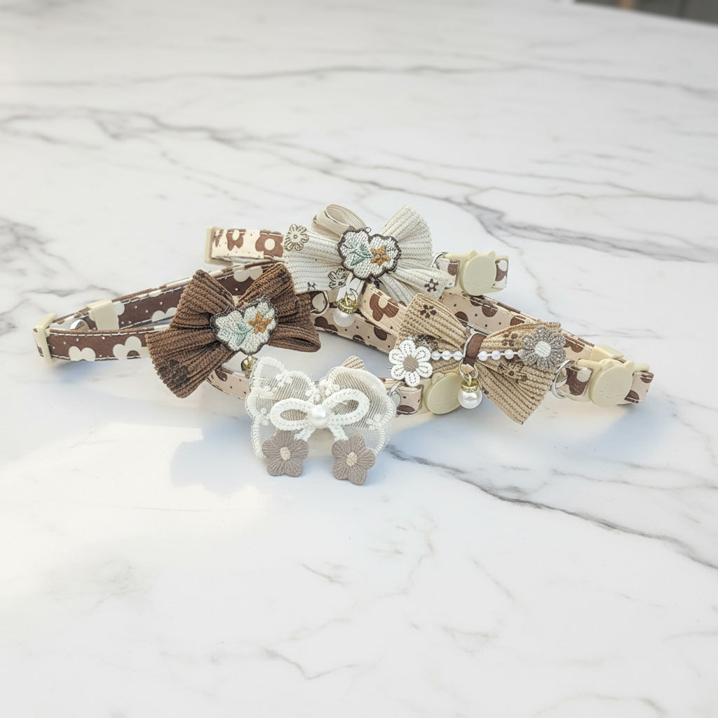 Mokka bow cat collar with floral charm photographed with natural lighting