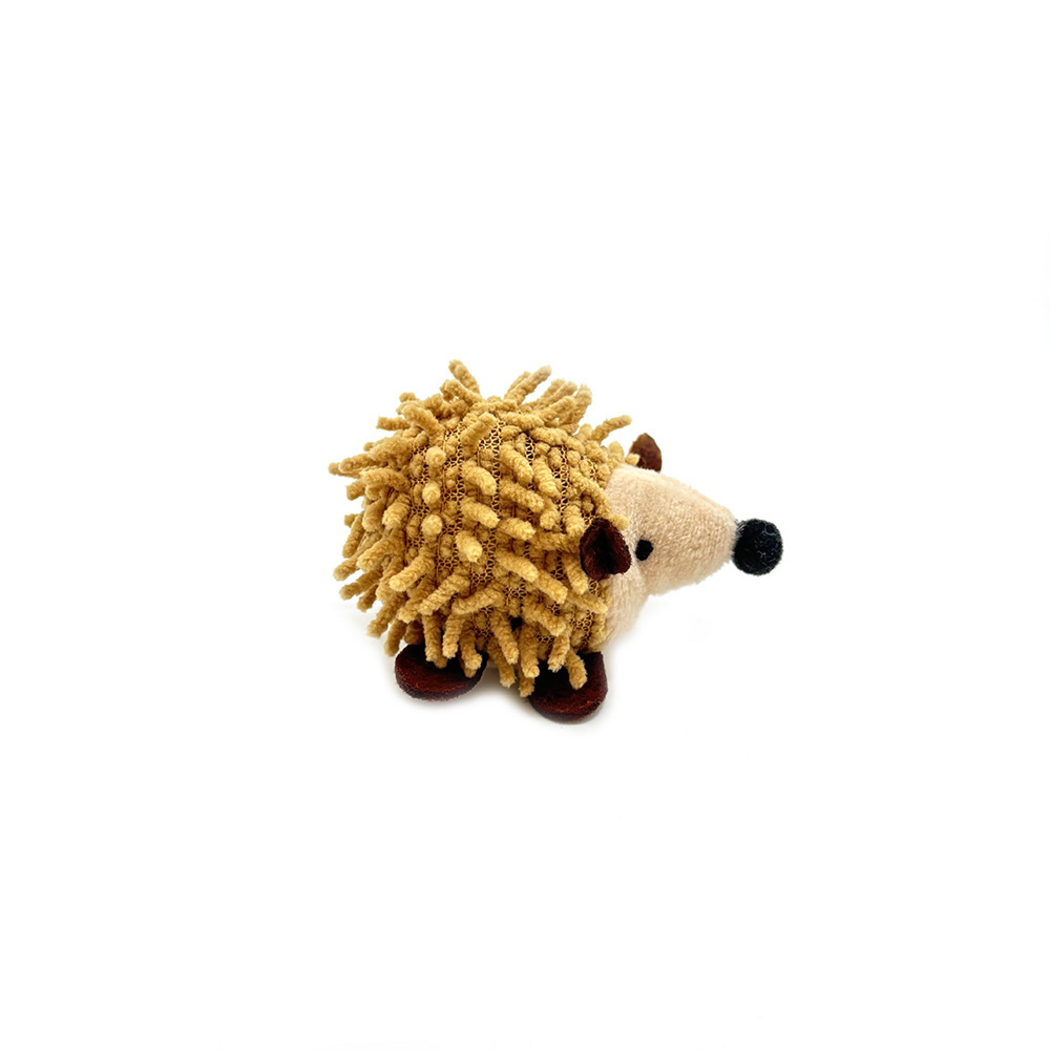 Hedgehog cat toy in side view, showing tan textured strands and brown feet