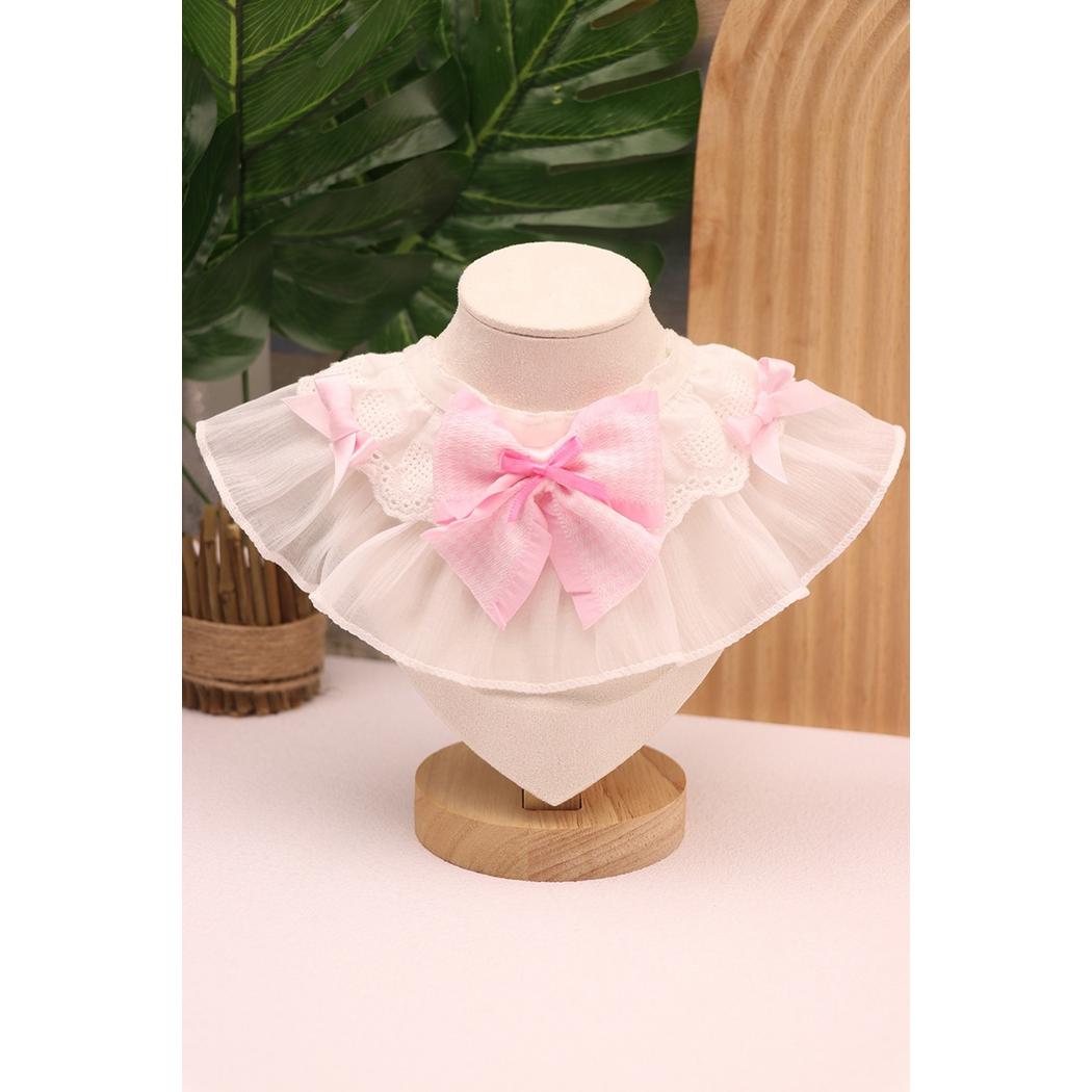 Pink Pet Neckwear with a large central bow, smaller bright pink bow and white ruffled edging on a stand