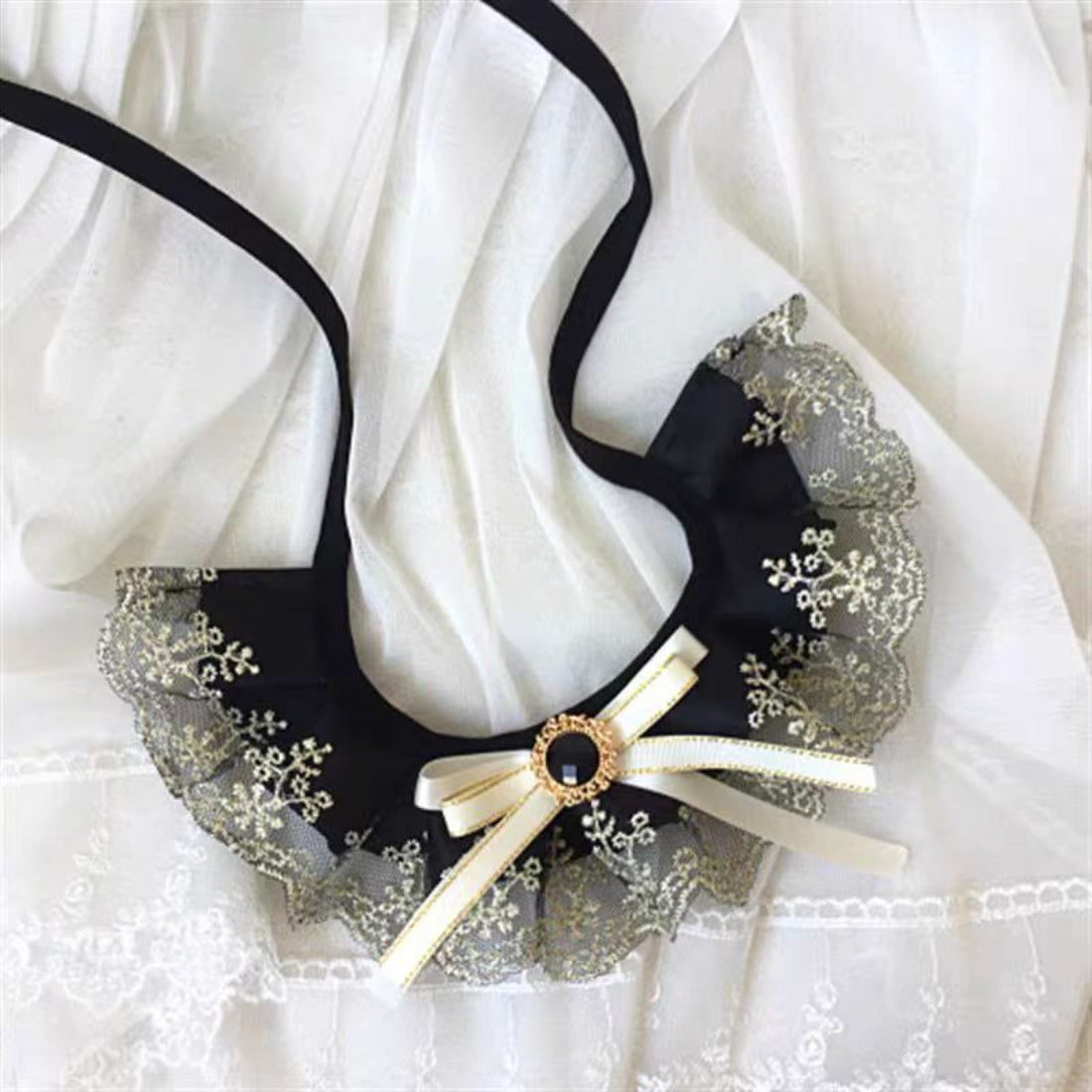 Close-up of Mokka black ruffle cat collar showing texture and buckle detail