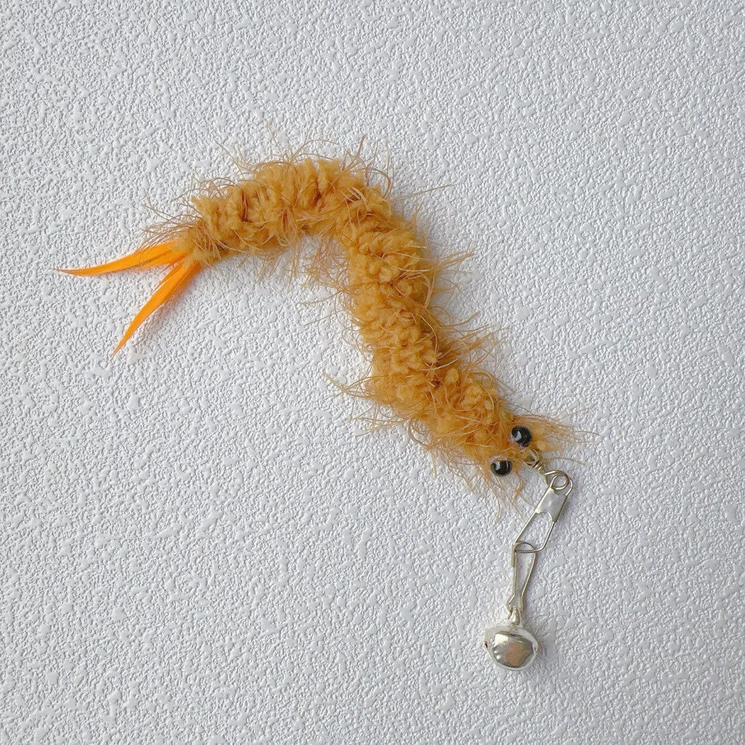 Brown fuzzy cat teaser replacement toy with orange tail feathers, clip, and bell