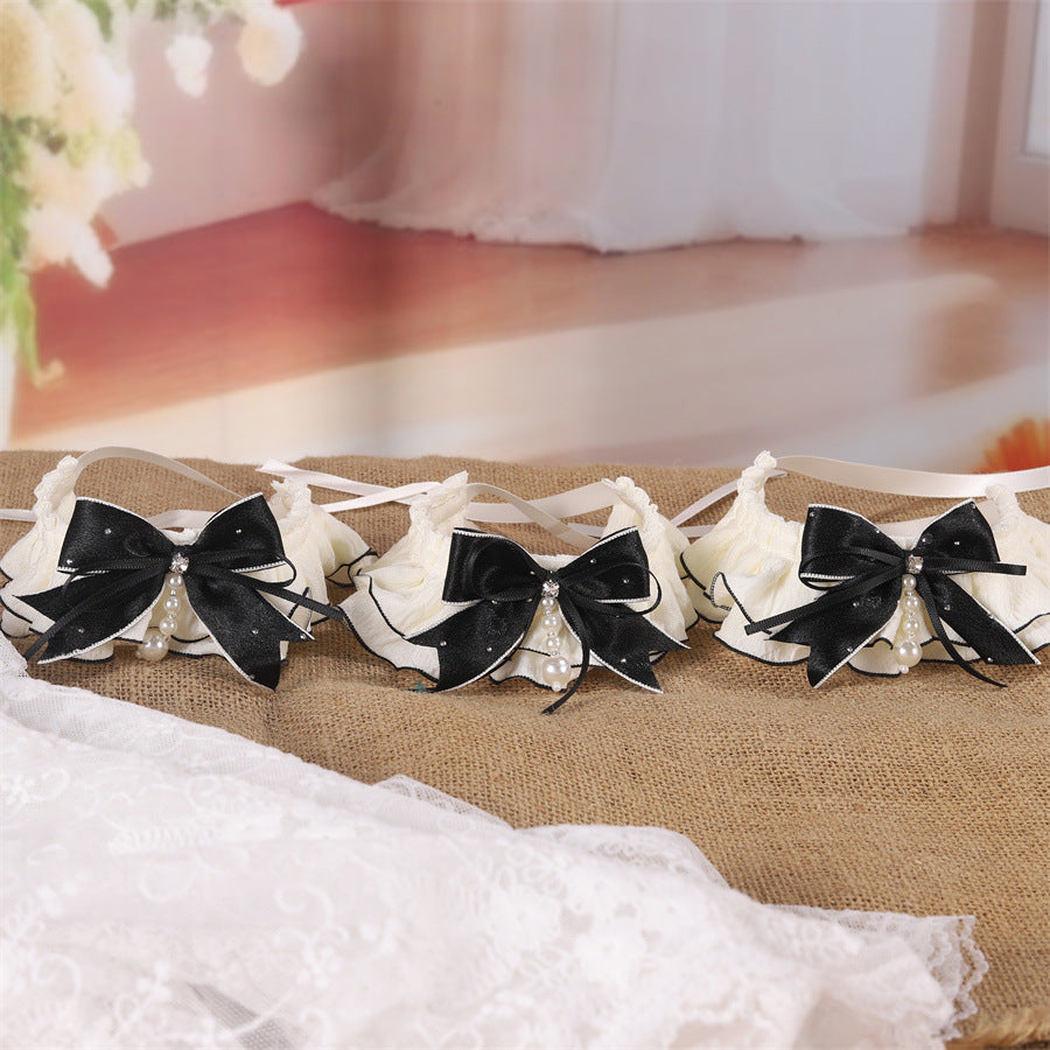 Three ivory ruffled pet neckwear pieces arranged in a wide display