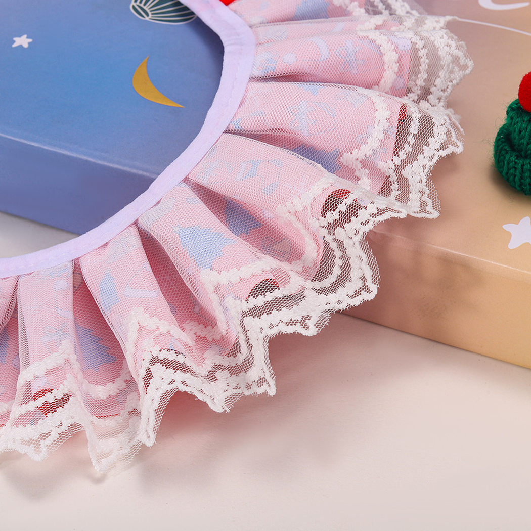 Close-up of the layered white lace-look ruffle and curved neck edge