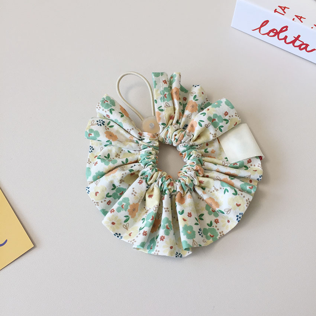 Reverse view of Yellow floral ruffled Pet Neckwear showing the gathered center, loop, and back of the tag.