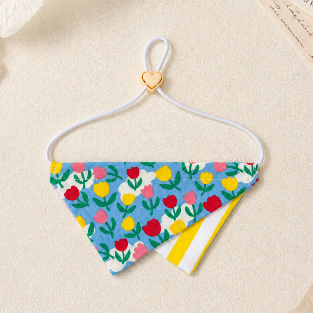 Tulip pet neckwear with multicolor flower print on blue, layered striped point, and heart-shaped connector