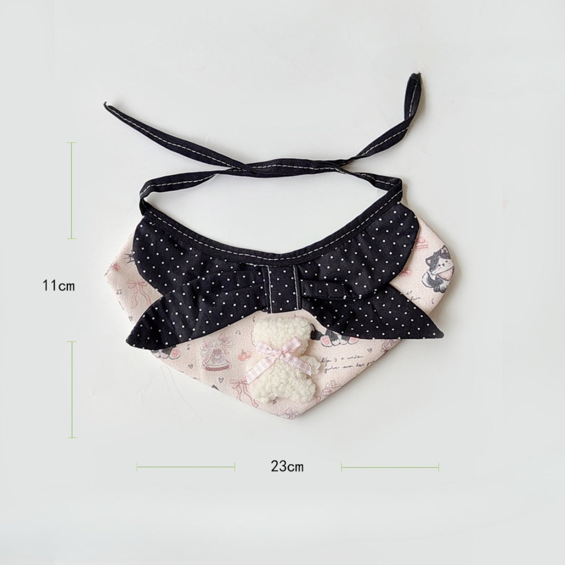 Side angle of pink cartoon cat neck bib highlighting soft fabric texture