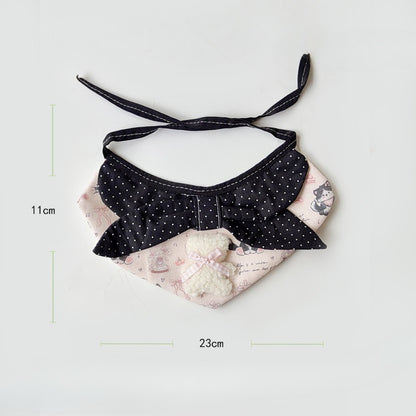 Side angle of pink cartoon cat neck bib highlighting soft fabric texture