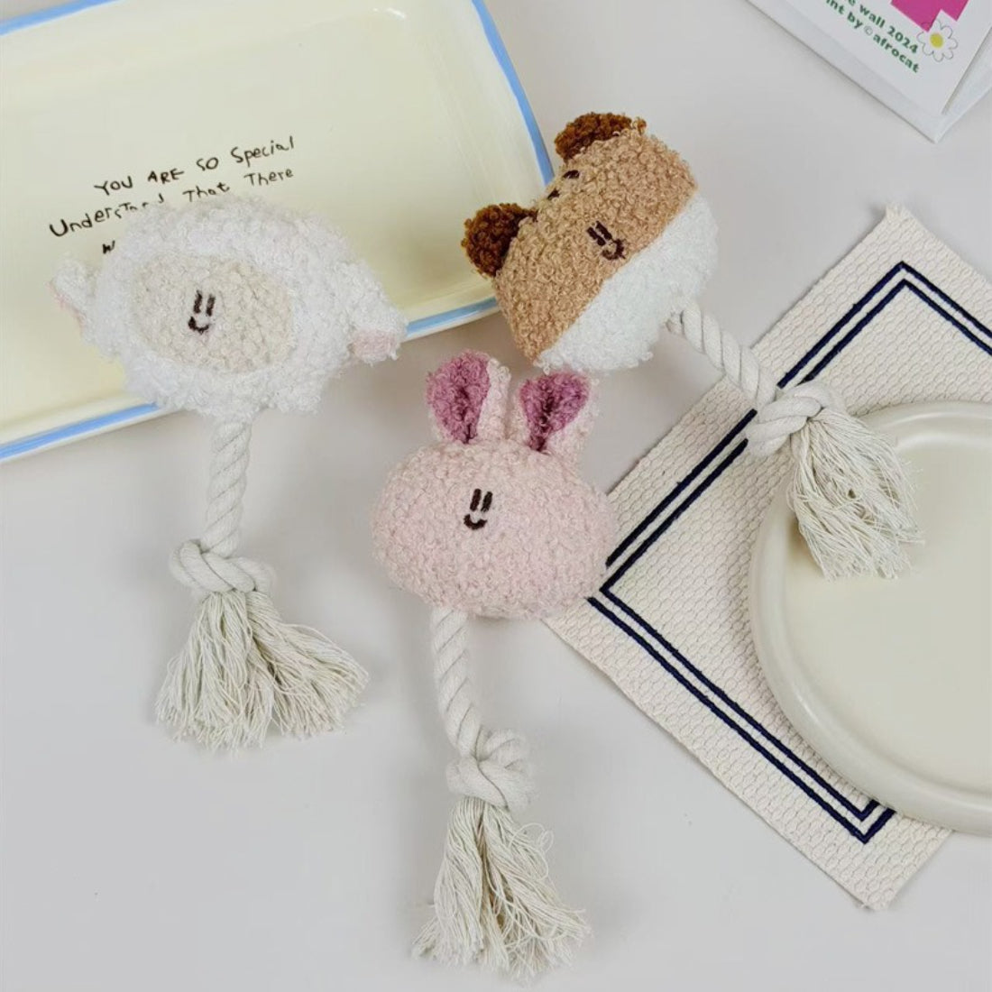 Petkin animal plush dog toy shaped like a brown and white dog with rope tail