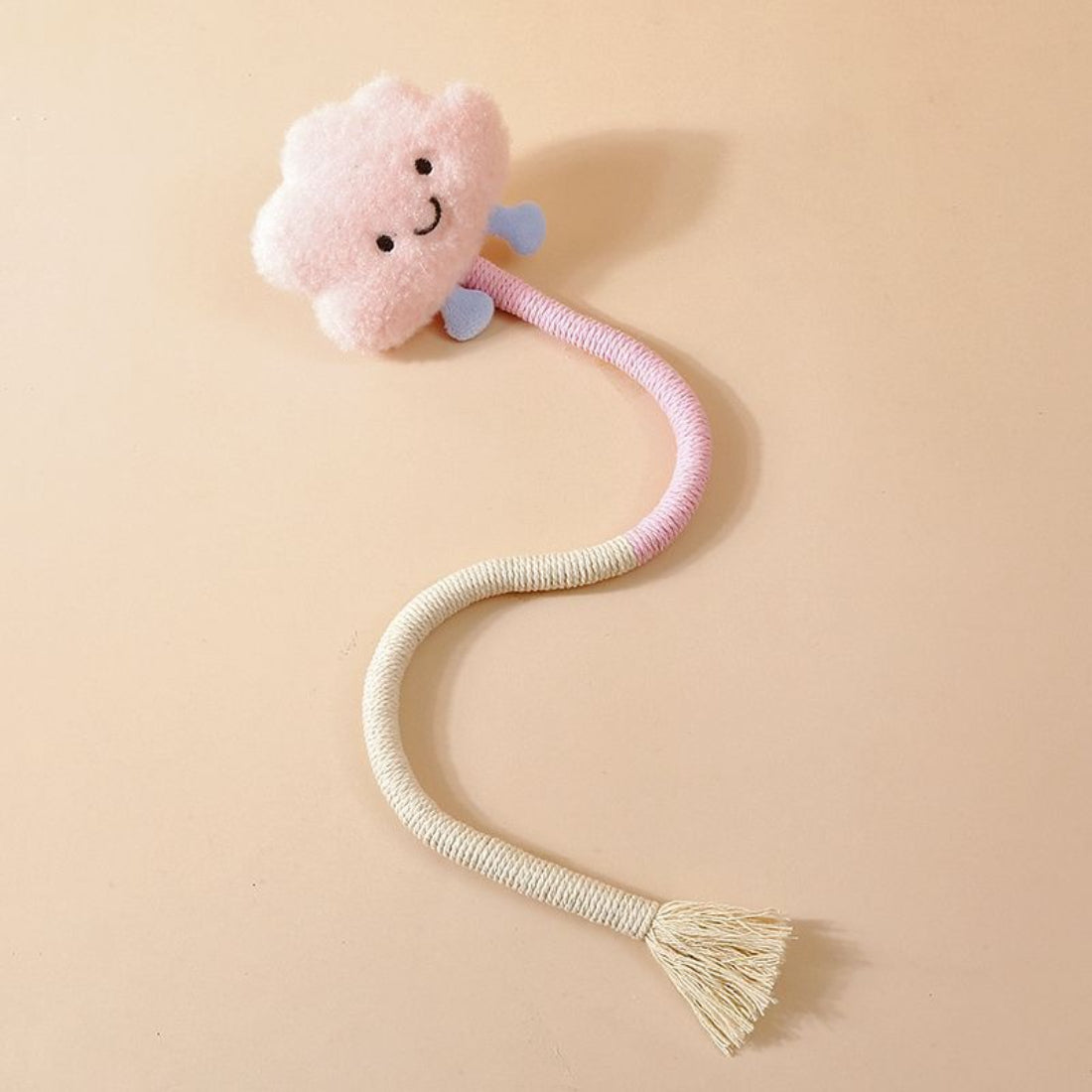 Cat reaching out to grab the plush charm on the Moo interactive wand toy