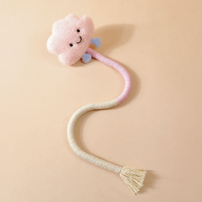 Cat reaching out to grab the plush charm on the Moo interactive wand toy