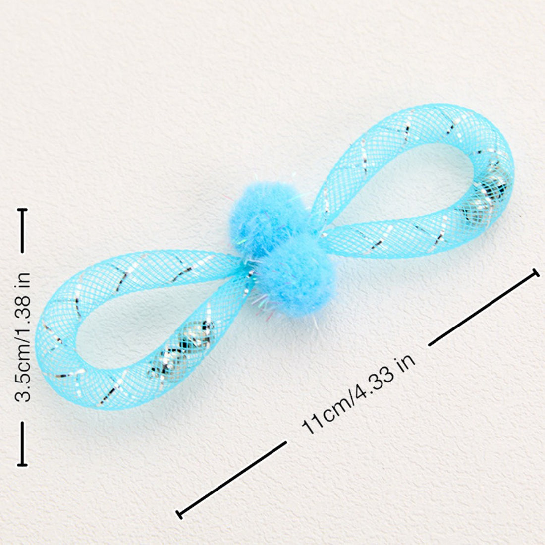 Close-up of Moo cat toy showing detailed mesh texture and bright pom-pom