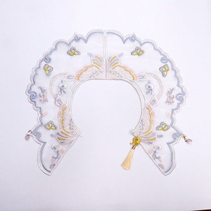 Mokka butterfly embroidered cat collar partially coiled on a plain surface