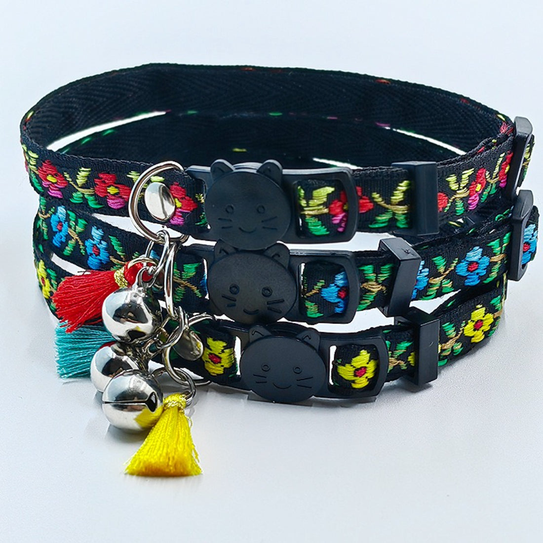 Close-up of Mokka floral cat collar showing tassel and small bell detail