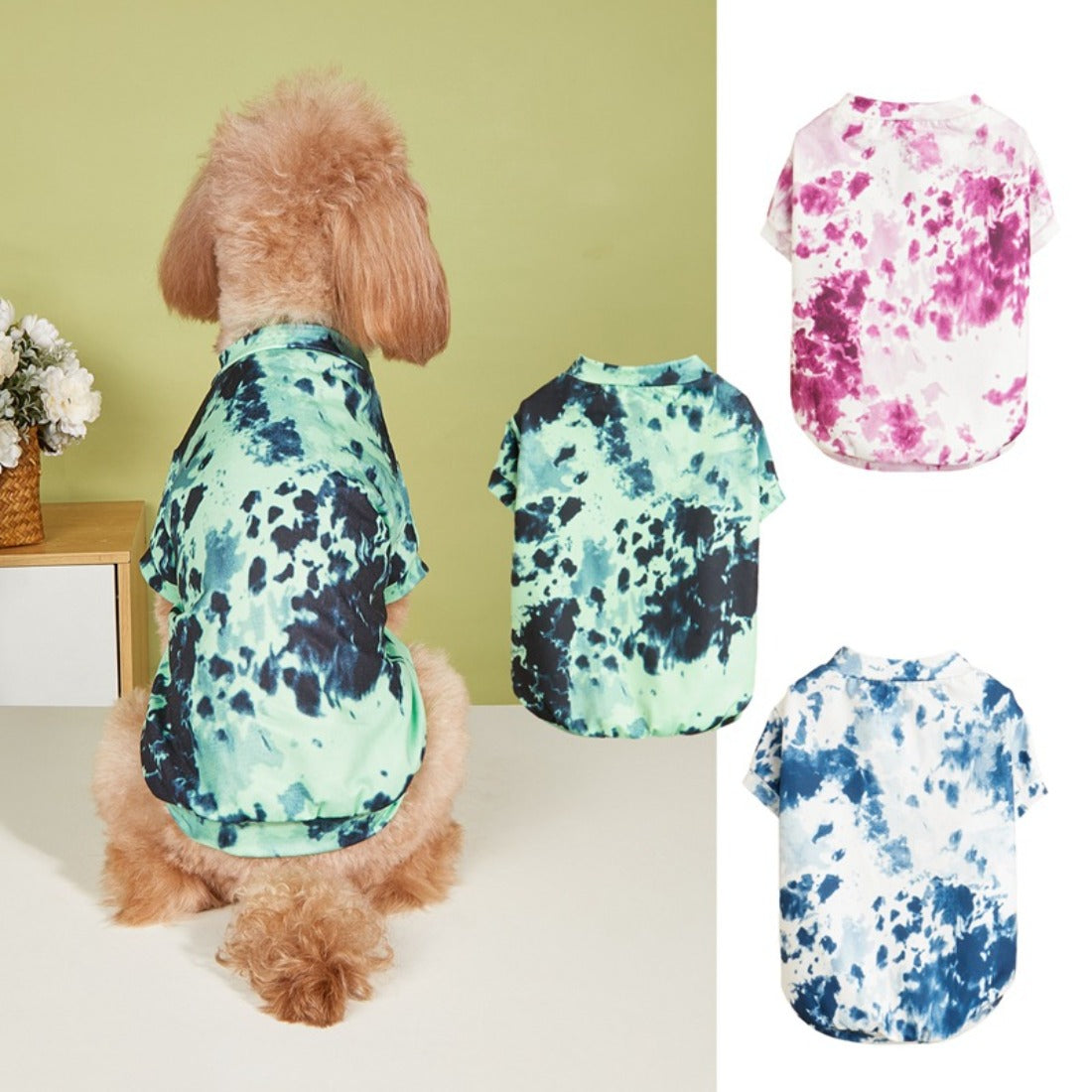 Small dog wearing a colorful tie dye t-shirt sitting on a wooden floor