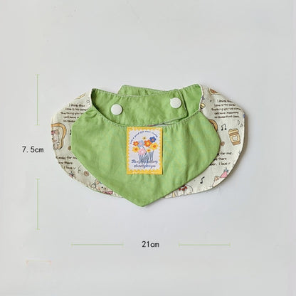 Mokka bib laid flat showing full cartoon cat artwork and shape