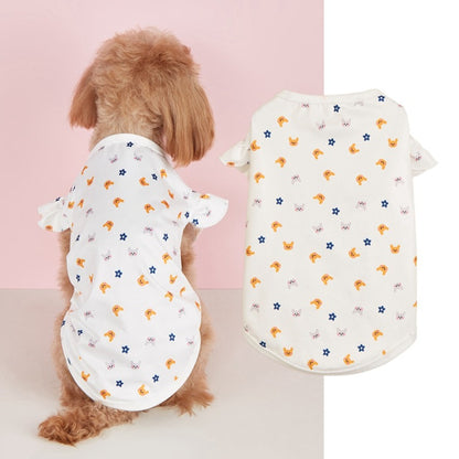 Ozzie dog wearing a cute print ruffle t-shirt sitting on a wooden floor