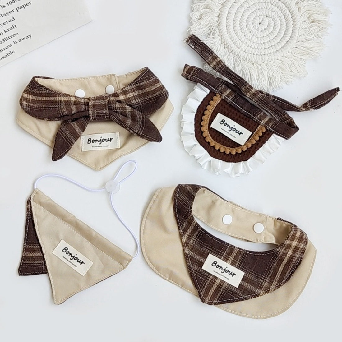 Brown ruffle cat bib with adjustable strap on a white background