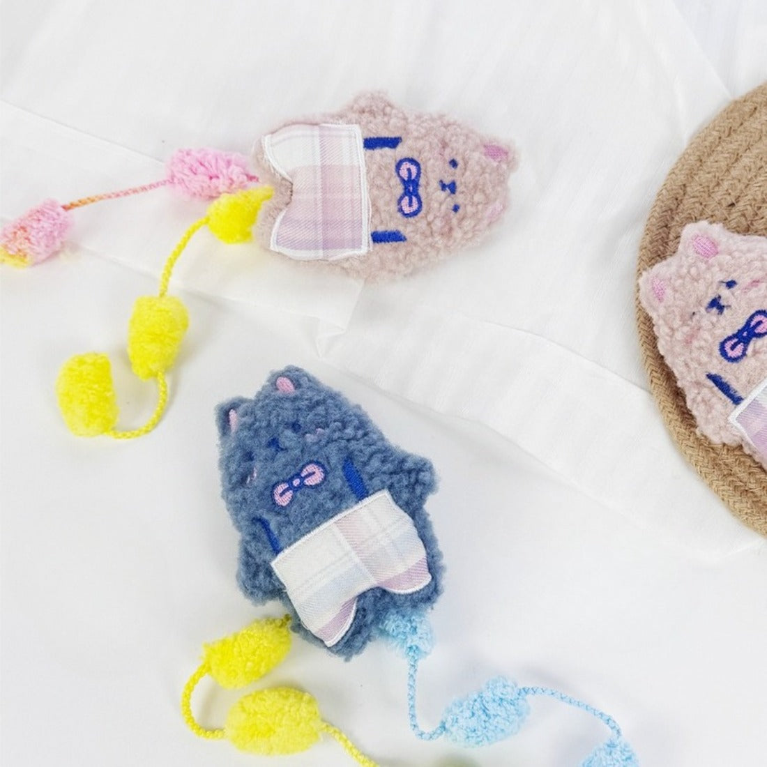 Close-up of Moo cat toy showing detailed stitching and vibrant pom tail