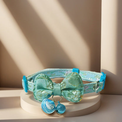 Mokka Bow Charm Cat Collar coiled to show bow charm and bell from above