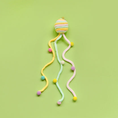 Moo colorful toss cat toy displayed on a flat surface highlighting its interactive features