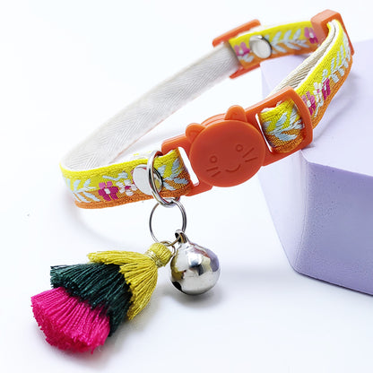 Mokka floral cat collar with tassel and bell shown from above on plain background