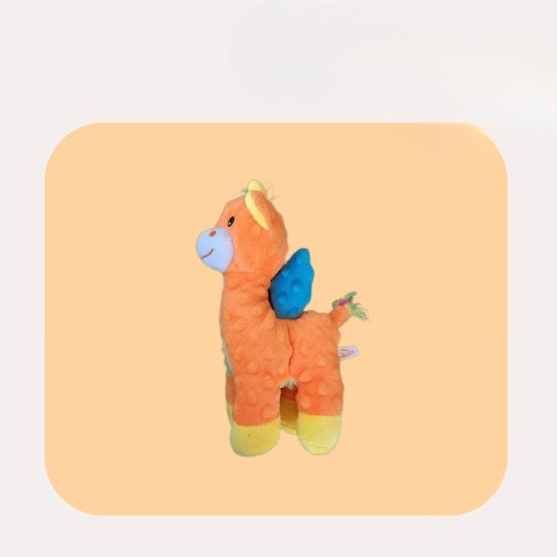 Petkin Winged Horse dog plush toy laying on a white surface with wings spread