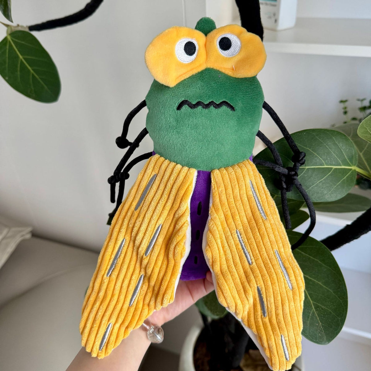 Group of assorted plush insect cat toys arranged together on a flat surface