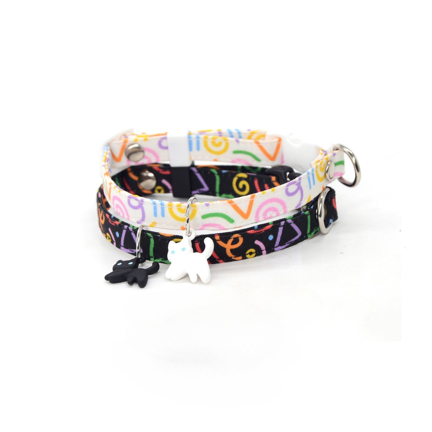 Black breakaway collar with silver cat charm displayed on wooden surface