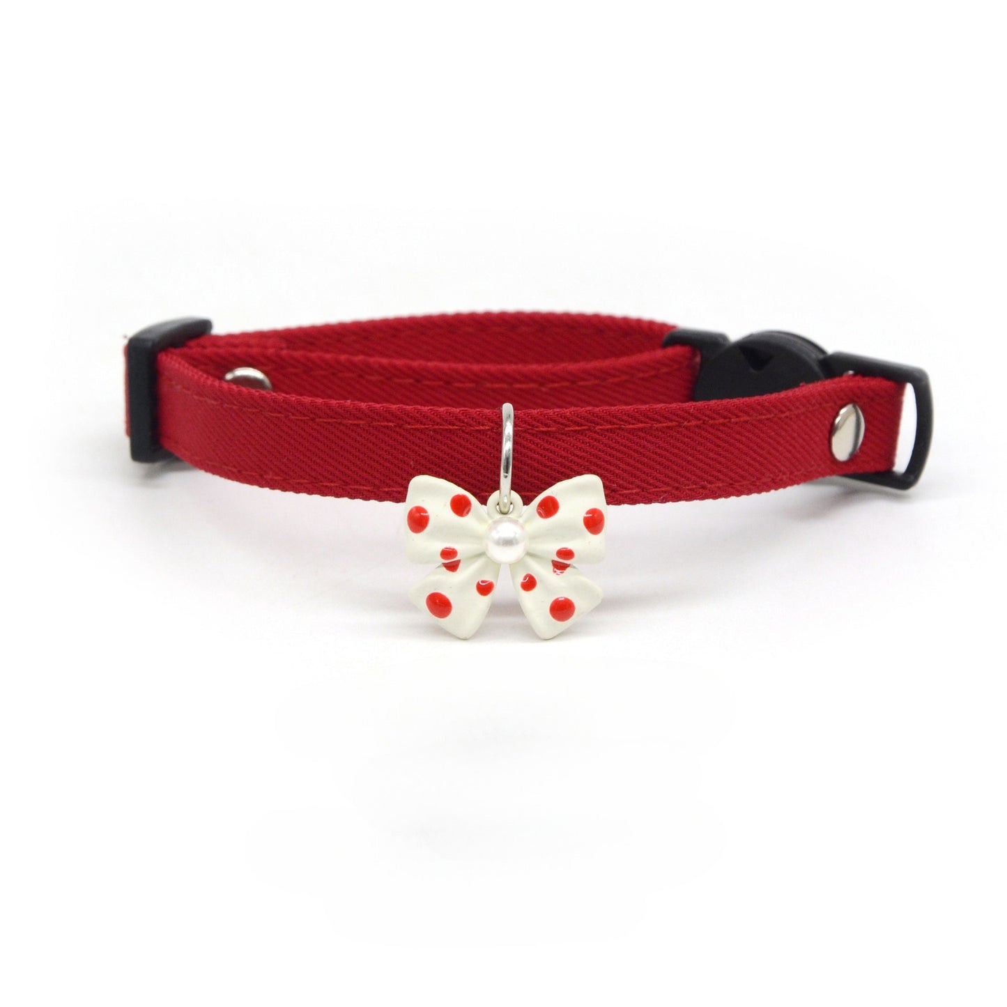 Mokka collar worn on a small dog highlighting the polka dot design and bow charm