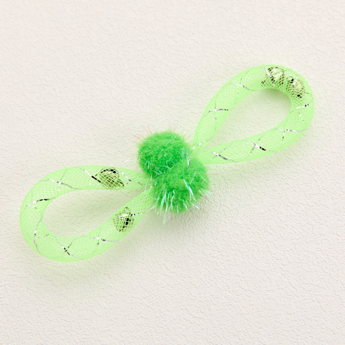 Side view of Moo mesh and pom-pom cat toy highlighting the pom-pom size and mesh shape