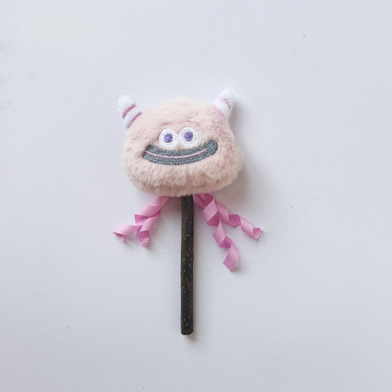 Side view of Moo monster cat stick toy highlighting plush monster head and feathers