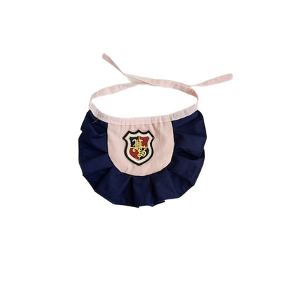 Mokka Academy Badge Cat Bib folded neatly to show compact size and badge detail