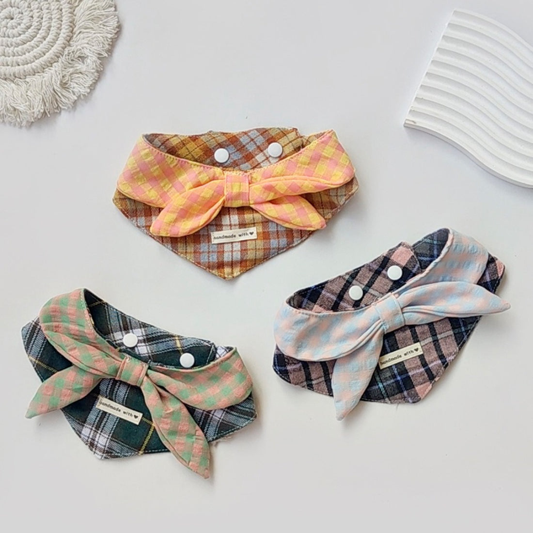 Mokka cat wearing a layered plaid bib with adjustable straps