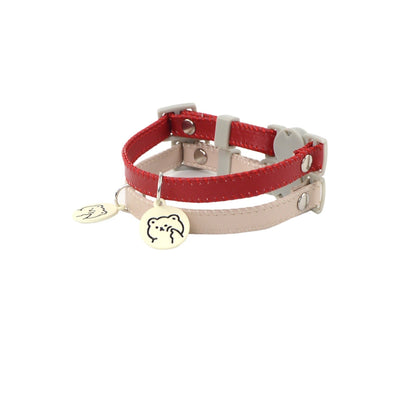Close-up of Mokka cat collar showing breakaway safety clasp and attached cartoon charm
