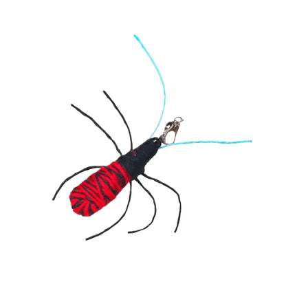 Close-up of colorful spider refill attachment showing detailed legs and bright orange body