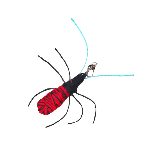 Close-up of colorful spider refill attachment showing detailed legs and bright orange body