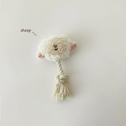 Petkin animal plush dog toy held in hand to show size and rope tail