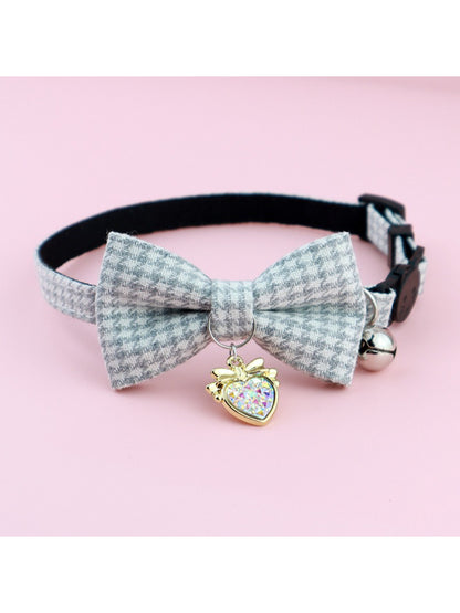 Mokka houndstooth bow bell cat collar laid flat showing buckle and bell