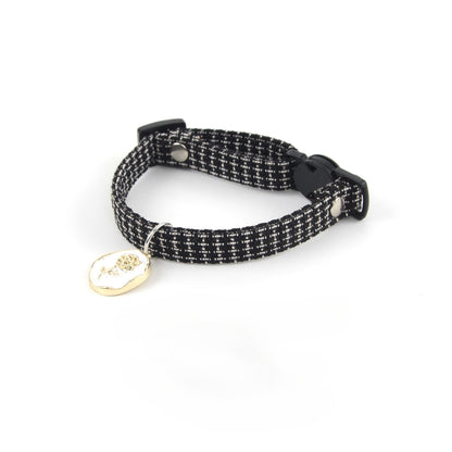 Pink cat collar with rose charm and breakaway buckle laid flat