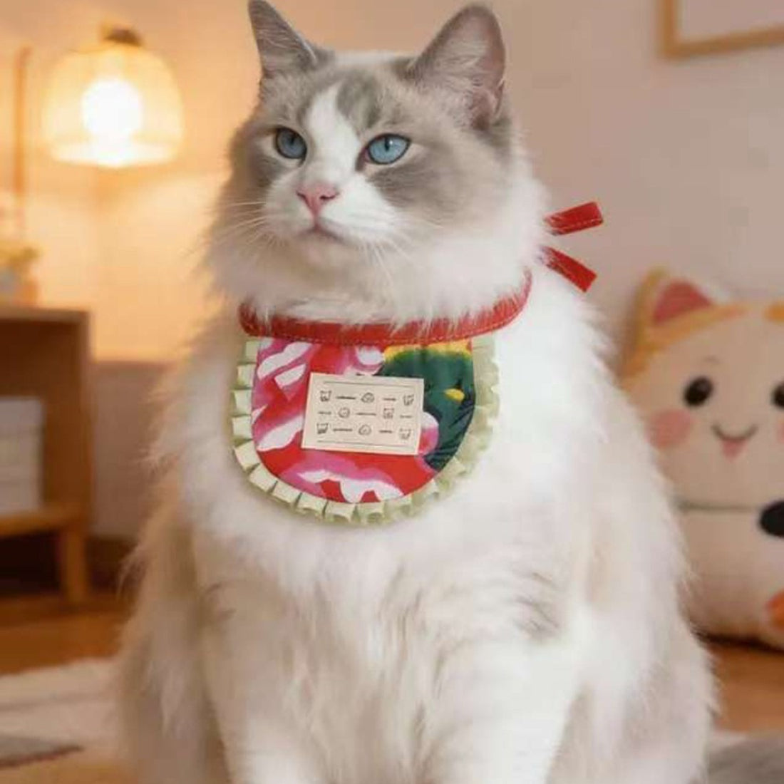 Close-up of Mokka cat bib fabric with detailed print and ruffle trim