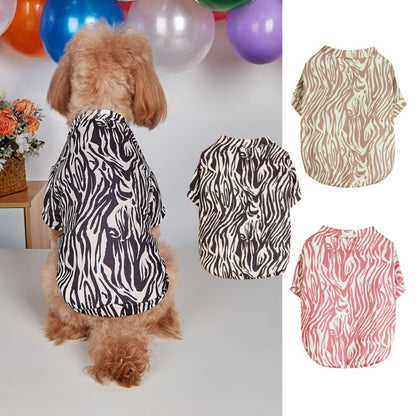 Small dog wearing Ozzie zebra print t-shirt standing on white background