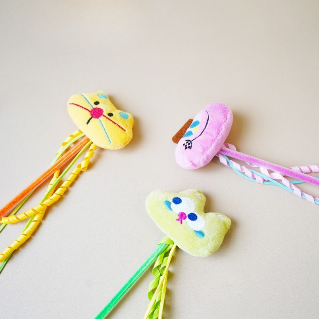 Close-up of Moo plush cat teaser wand showing detailed stitching and fabric texture